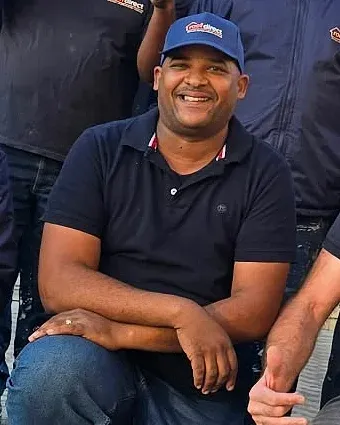 Randall Swarts, foreman at Roof Direct, smiling in a Roof Direct cap and shirt